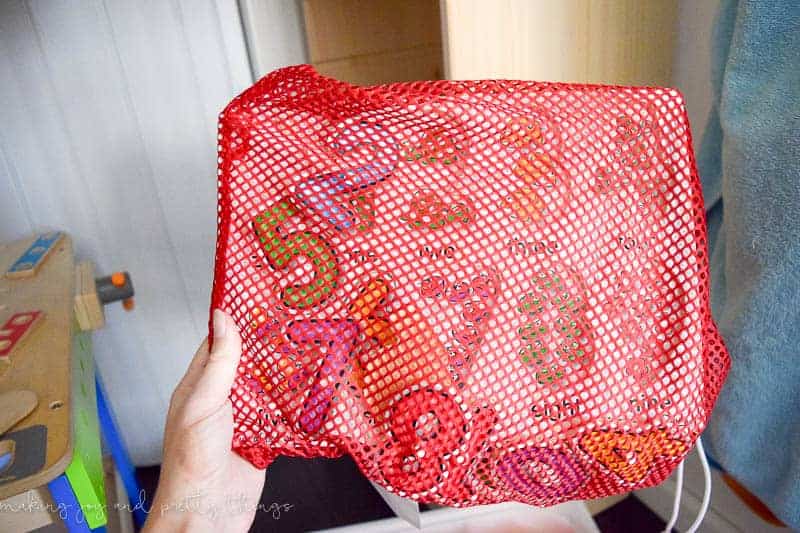 If you are organizing puzzles or games with small pieces, use mesh sports bags to contain everything.