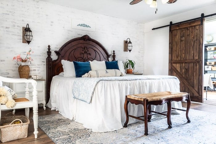 This european master bedroom looks gorgeous with this large 9x12 blue and white rug pulled forward so it is out from the nightstands, providing enough room to add a bench to the end of the bed