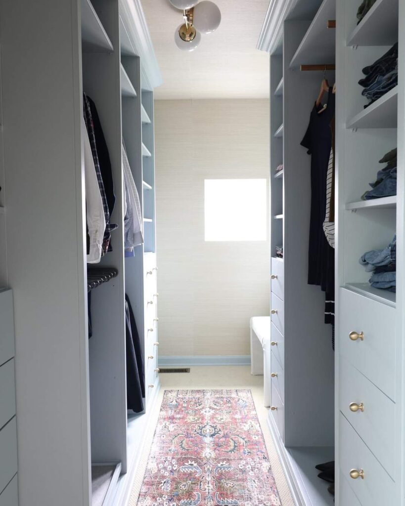 Master closet with built-ins painted with Benjamin Moore Smoke 2122-40 with runner rug on the floor and tan wallpaper on the wall