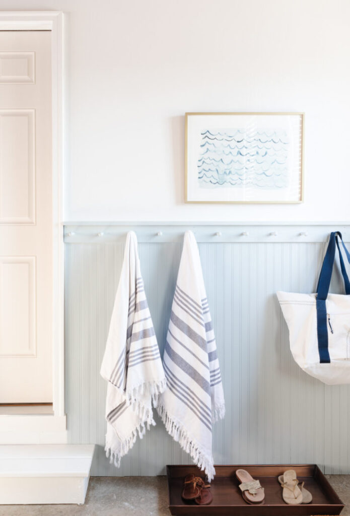 Mudroom with beadboard and peg rail added to the lower part of the walls painted with Benjamin Moore's smoke paint color, a gorgeous shade of blue green with white painted on the wall above it