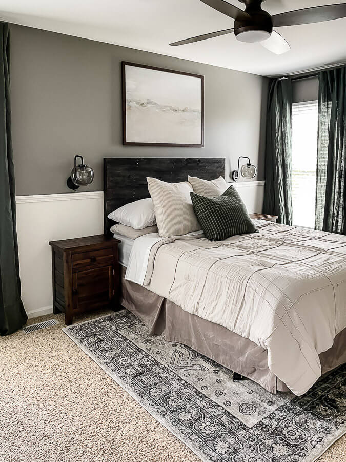A 6x9 rug under this Queen bed looks great in this guest bedroom with the bed side table.