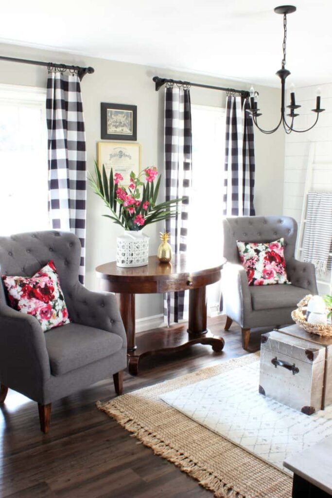 A photo of a neutral patterned rug on the floor of a dining room, creating an interesting texture and adding warmth to the space.