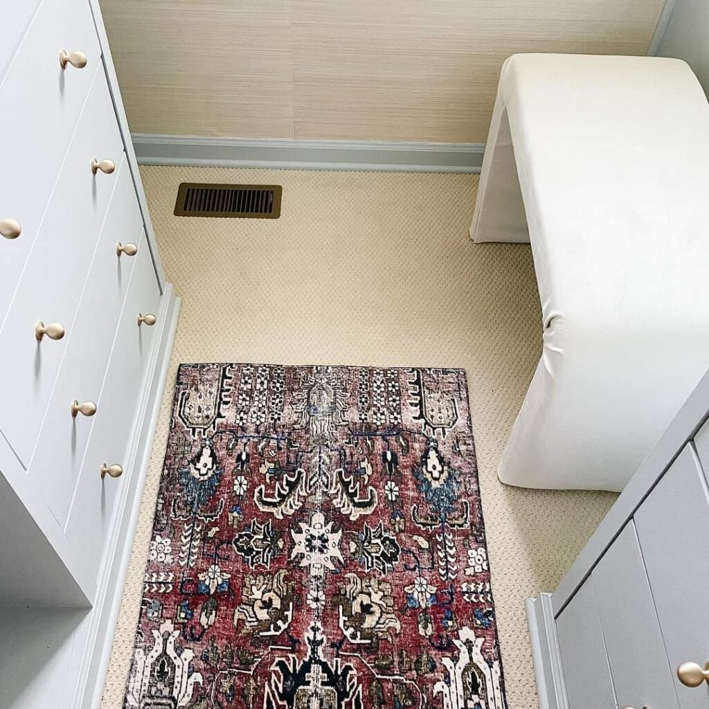 A close-up photo of a bench, carpet and cabinet.