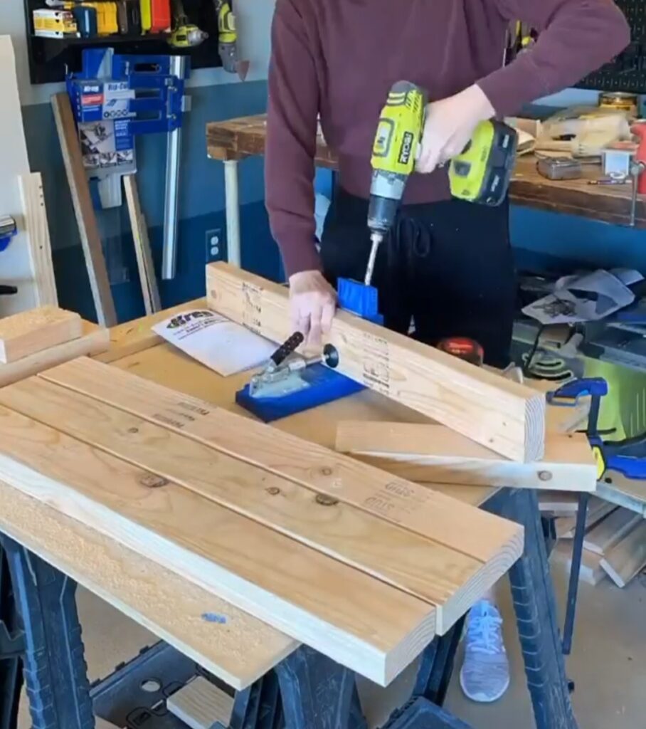 A woman drills a pocket hole for the bench.