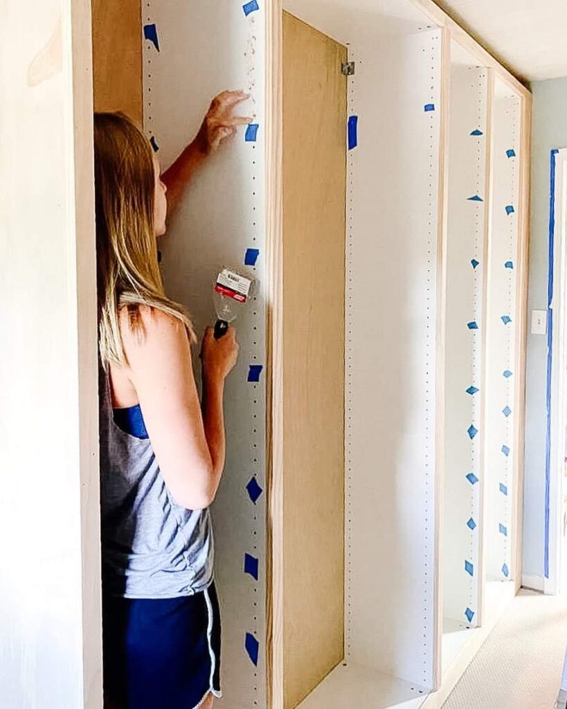 Filling the shelf pin holes on an IKEA Pax wardrobe.