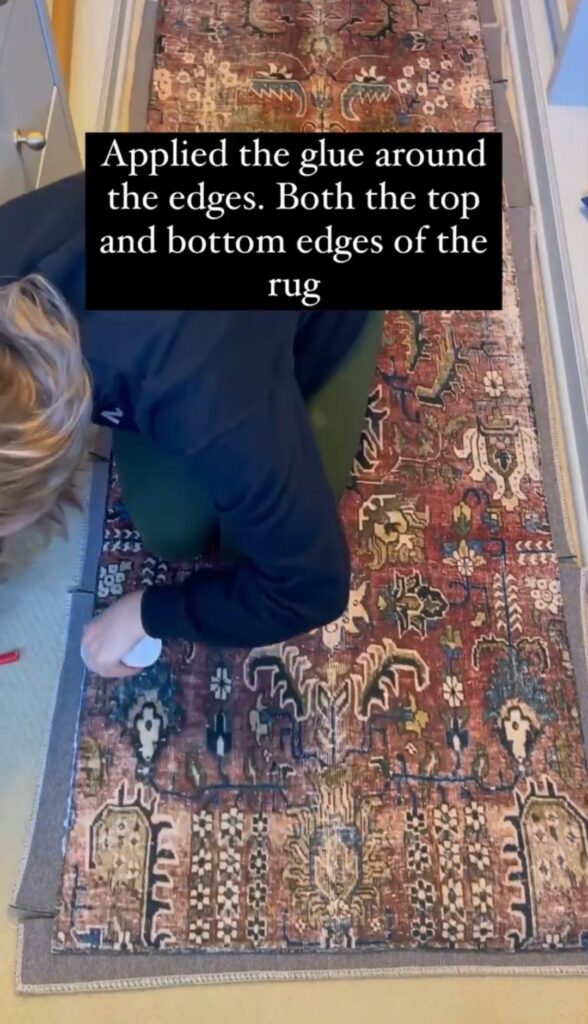 A women glued the edges of the rug.